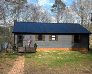 Completed black metal roofing installation on winner's home.
