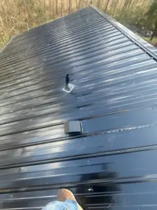 Glossy black metal roofing on sweepstake winner's roof in Blacksburg, SC.