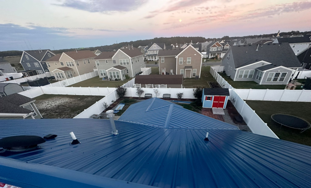 Unveiling the Modern: Contemporary Home Designs and Standing Seam Metal Roofs 1 A house with a blue metal roof installed by Gator Metal Roofing