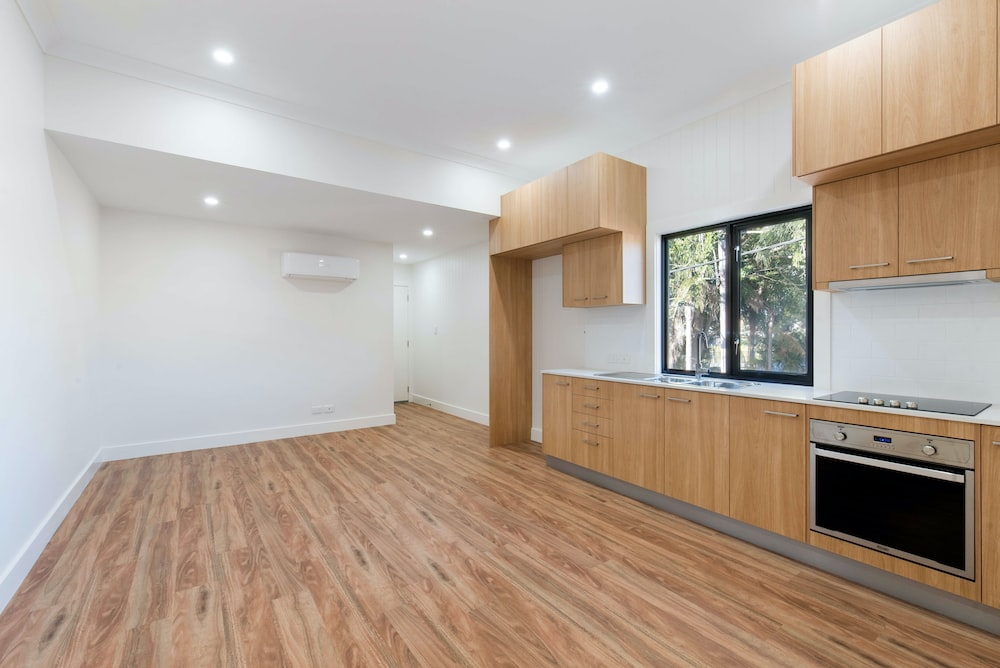 A large kitchen area with wooden floors