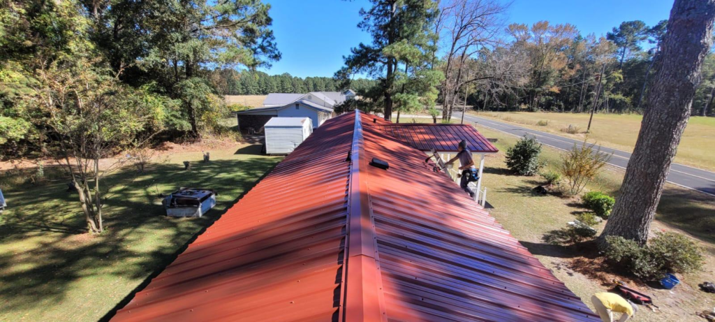 A person on a red metal roof