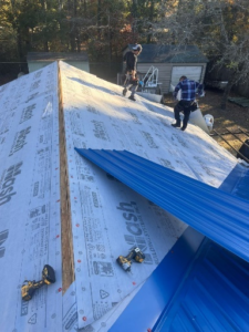 Roofing contractors in NC installing a new metal roof