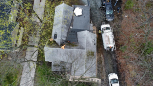Aerial view of a residential property in need of roof repairs.