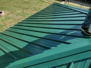 A roof of a residential property painted in green color.