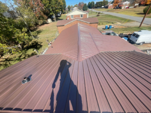 Shadow of a person on a brown metal roof