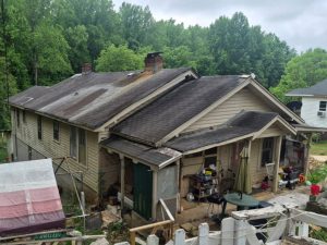 Asphalt shingles before roof repair and new ENERGY STAR metal roof installation in Greenville, SC.