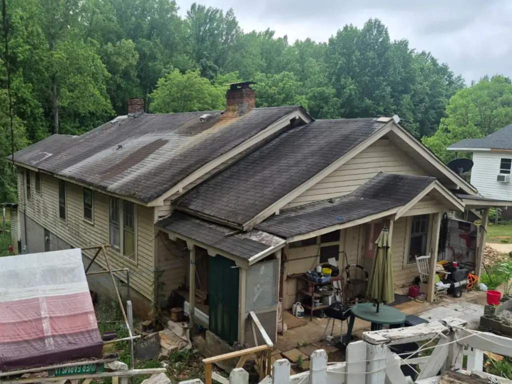 Asphalt shingles before roof repair and new ENERGY STAR metal roof installation in Greenville, SC.