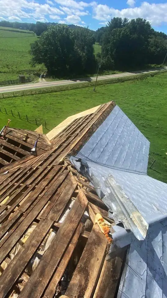 Before Gator Metal Roofing: Exposed rafters under poly material