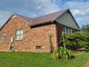 Completed metal roofing installation on a brick home in Winston-Salem, NC.