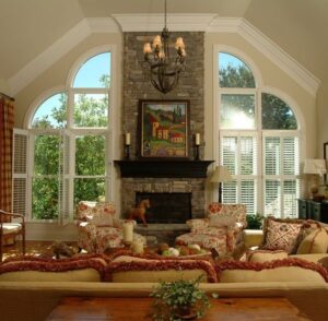 Beautiful double-hung windows framing a stone fireplace, available at Gator Metal Roofing.