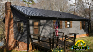 Blog 20 Gator's glossy black metal roofing on a traditional North Carolina.