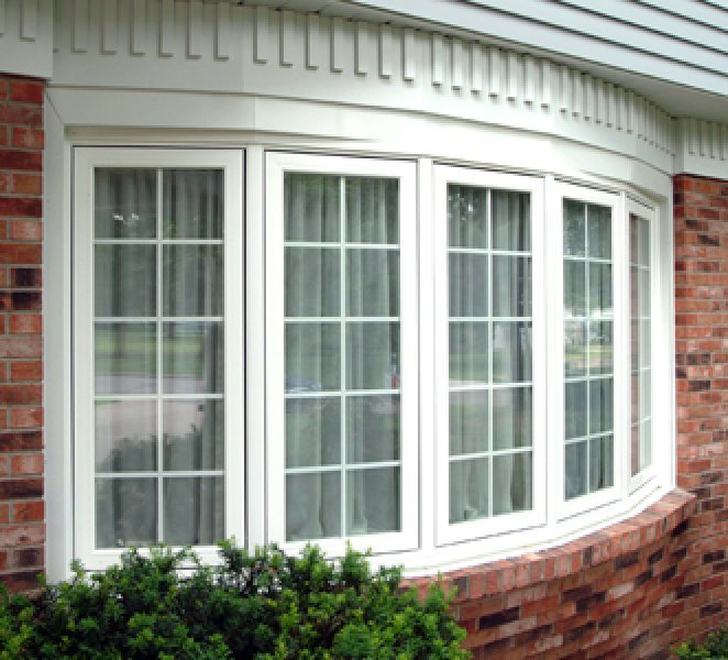 White bow windows with a classic grid profile from Gator Metal Roofing.