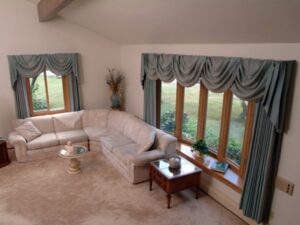 Bow windows with wood-grain frames available at Gator Metal Roofing.