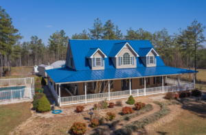 a modern home with a glossy blue metal roof by Gator Metal Roofing