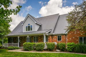 a modern home with a grey metal roof by Gator Metal Roofing